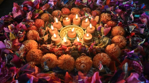 Diyas amongst colourful wreaths make up a Diwali display